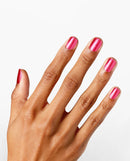 Hand with pink nail polish on a white background
