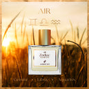 Perfume bottle labeled 'Air' from Zodiac Elements by Ambery Sky with a sunset background