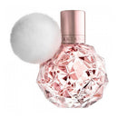 Perfume bottle with geometric design and rose gold cap on white background