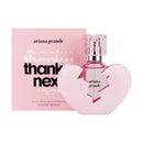 Ariana Grande perfume bottle and packaging with 'thank u, next' text on a white background