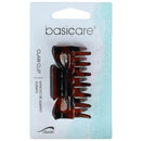 A pair of classic claw hair clips in a translucent amber-brown acetate, packaged on a white and light blue 'basicare' retail card.