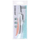 A packaged basicare eyebrow razor with a white handle, peach-colored blade, and black trim, shown in its clear retail blister pack against a white background.