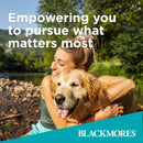 Woman hugging a dog with scenic background and Blackmores branding