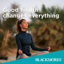 Woman meditating outdoors with 'Good health changes everything' text and Blackmores logo.