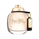 Coach women's perfume bottle with gold cap and tag on a white background