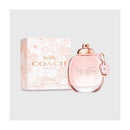 Coach floral perfume bottle and packaging on a light gray background