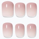 Six false press-on nails arranged in two rows of three on a plain white background. Each nail has a glossy ombre finish that fades from a soft dusty pink at the top to a very pale blush or near-white at the tip.