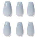 Six false press-on nails in a pale icy blue-gray color, arranged in two rows of three on a plain white background.