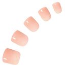Five false press-on nails in a soft peach-pink gradient, arranged diagonally on a solid white background.