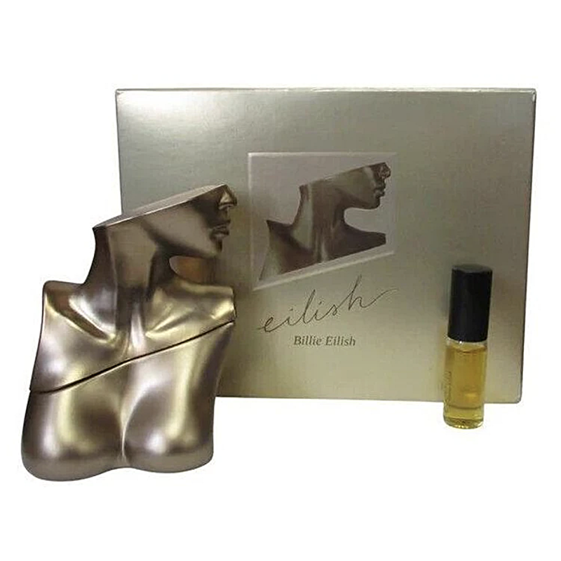 Perfume set with silver bottle, packaging, and small bottle labeled 'Billie Eilish' on a white background.