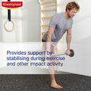Man exercising with a barbell in a gym setting, featuring Elastoplast branding.
