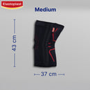 Black knee brace with red accents and measurements on a gray background, featuring the Elastoplast brand.