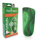 Packaging and a single green insole of the Footlogics Casual Large size, designed for correcting foot pronation and supporting arches.