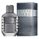 Guess Dare Eau de Toilette bottle in textured metallic silver glass next to its matching textured gray and silver box, on a plain white background.