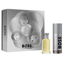 BOSS Bottled fragrance gift set featuring a silver box with large circular BOSS logos, a small clear bottle filled with pale yellow liquid, and a silver cylindrical deodorant or body spray canister, all on a white background.