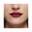Close-up of a person wearing a bold red lipstick on a neutral background