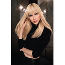 Woman with long blonde hair posing against a dark background