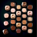 Collection of makeup products arranged in a grid on a dark background
