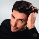 Man with styled hair against a neutral background