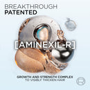 Advertisement for Aminexil-R growth and strength complex with metallic elements on a light background