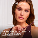 L'Oreal Paris advertisement with a woman holding a makeup product, featuring text about color intensity.