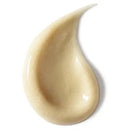 Close-up of a beige cream droplet on a white background