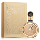 Gold perfume bottle and packaging with intricate designs on a white background