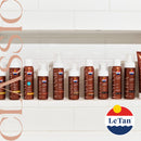 Row of Le Tan tanning products on a white tiled wall with the brand logo.