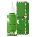 Green perfume bottle and packaging with floral design on a white background