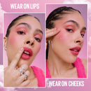 Makeup application on lips and cheeks with a pink background