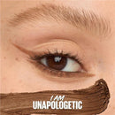 Close-up of an eye with brown makeup and 'I AM UNAPOLOGETIC' text.