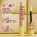 Maybelline mascara with yellow and pink design on a beige background