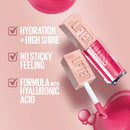 Lip gloss with pink liquid on a pink background, featuring text about hydration, high shine, no sticky feeling, and hyaluronic acid formula.