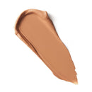 Swatch of brown makeup cream on a white background