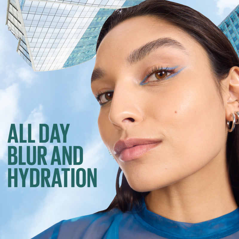 Woman with blue eyeshadow against a cityscape background with text 'All Day Blur and Hydration'.