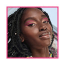 Close-up of a person with pink eye makeup and braided hair, framed by a pink border.