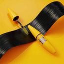 Yellow mascara tube with black hair extensions on a yellow and orange background