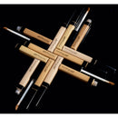 Makeup brushes and applicators arranged in a cross pattern on a black background