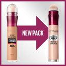 Two Maybelline Instant Age Rewind Eraser concealer bottles with a new packaging arrow between them on a light gray background.