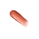Nude-colored lip gloss on a white background
