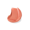 Coral-colored lip balm on a white background