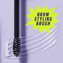 Brow styling brush with clear handle and black bristles on a purple background, labeled 'Brow Styling Brush'.