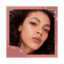 Close-up of a woman's face with a soft pink border