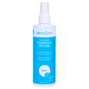A bottle of MooGoo Natural Tanning Water spray, featuring a white plastic bottle with a white spray nozzle and a bright blue label, set against a plain white background.