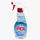 A bottle of Moschino Fresh Couture Eau De Toilette with a blue label and a red spray nozzle.