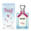 A bottle of Moschino Funny! Eau De Toilette with a pink ribbon on the neck, alongside its blue and white packaging box, featuring heart illustrations.