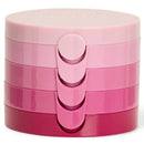 A stack of four round cosmetic compacts in a glossy pink gradient, with the brand name 'NATIO' embossed on the top lid, set against a plain white background.