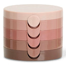 A stack of four round cosmetic compacts in a glossy gradient of dusty pink, mauve, rose, and brown, with the brand name 'NATIO' embossed on the top lid, set against a plain white background.