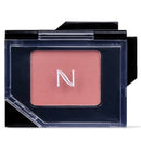 A single-pan blush compact with a dusty rose pink powder and a white stylized 'N' logo on the front, housed in a black case with a clear plastic cover.