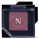 A single-pan glitter eyeshadow compact by Naked, featuring a sparkling mauve-pink shade with a white 'N' logo in the center, set in a clear plastic case with a black lid.